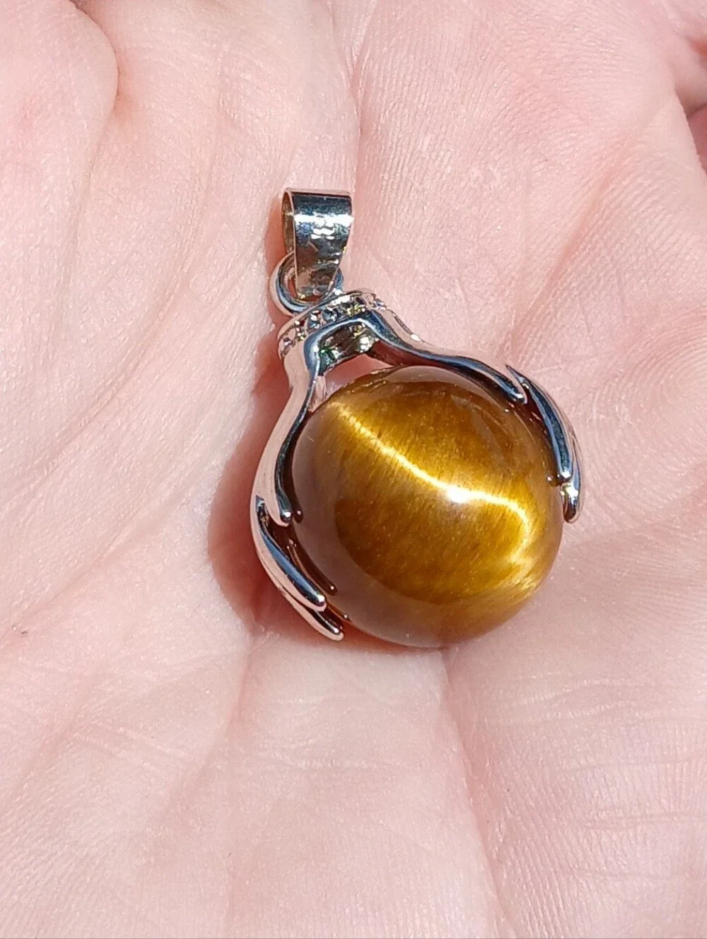 Handmade stone pendant holding